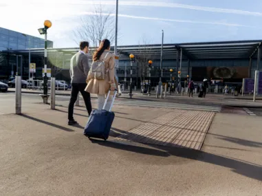 full shot couple walking with baggage